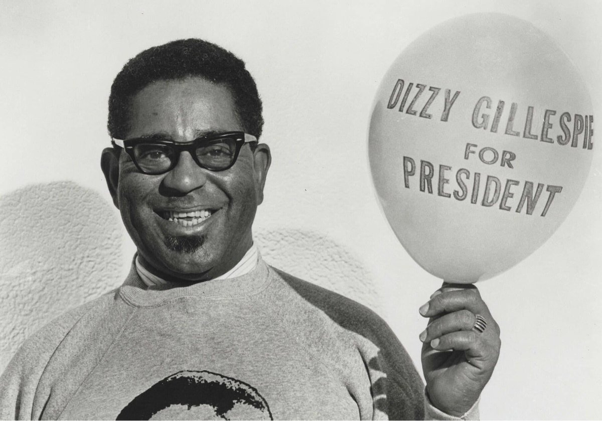 Dizzy Gillespie holding a balloon that says 'Dizzy Gillespie for President'