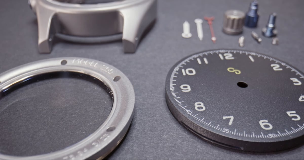 a bunch of watch pieces laying on a table