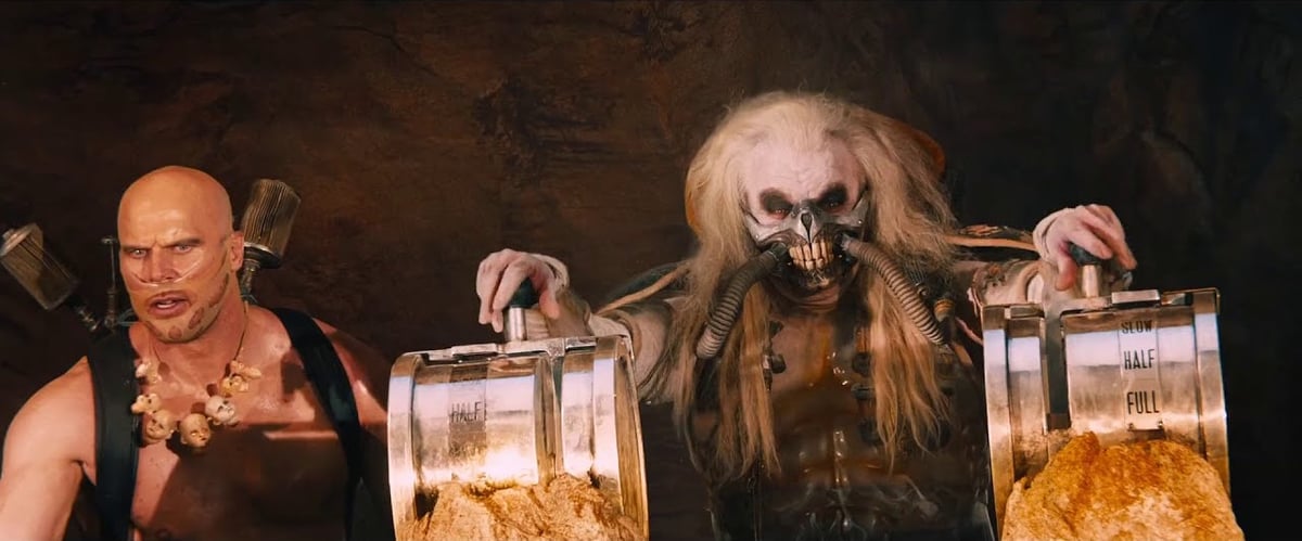 in a screenshot from Mad Max: Fury Road, Immortan Joe stands poised at the controls for the water