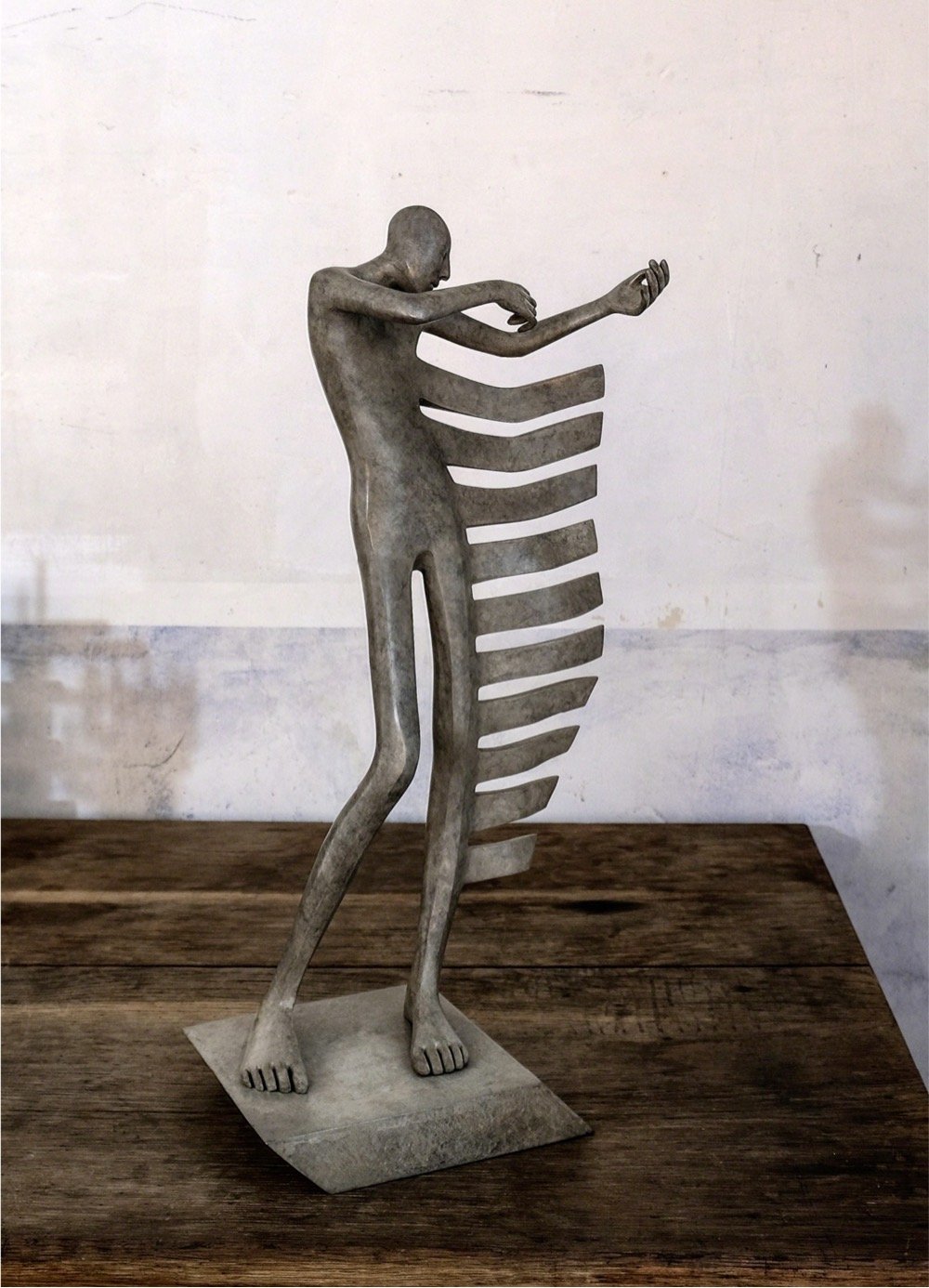 sculpture of a man playing an invisible violin