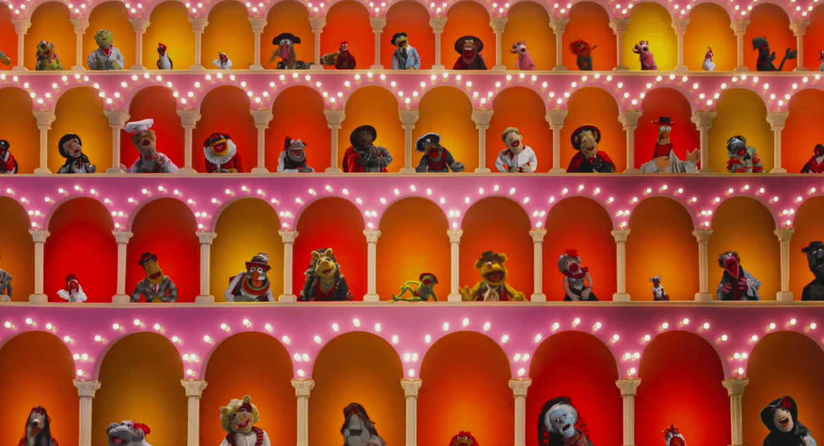 a still from the opening credits of The Muppet Show, showing all of the puppet entertainers in stage windows