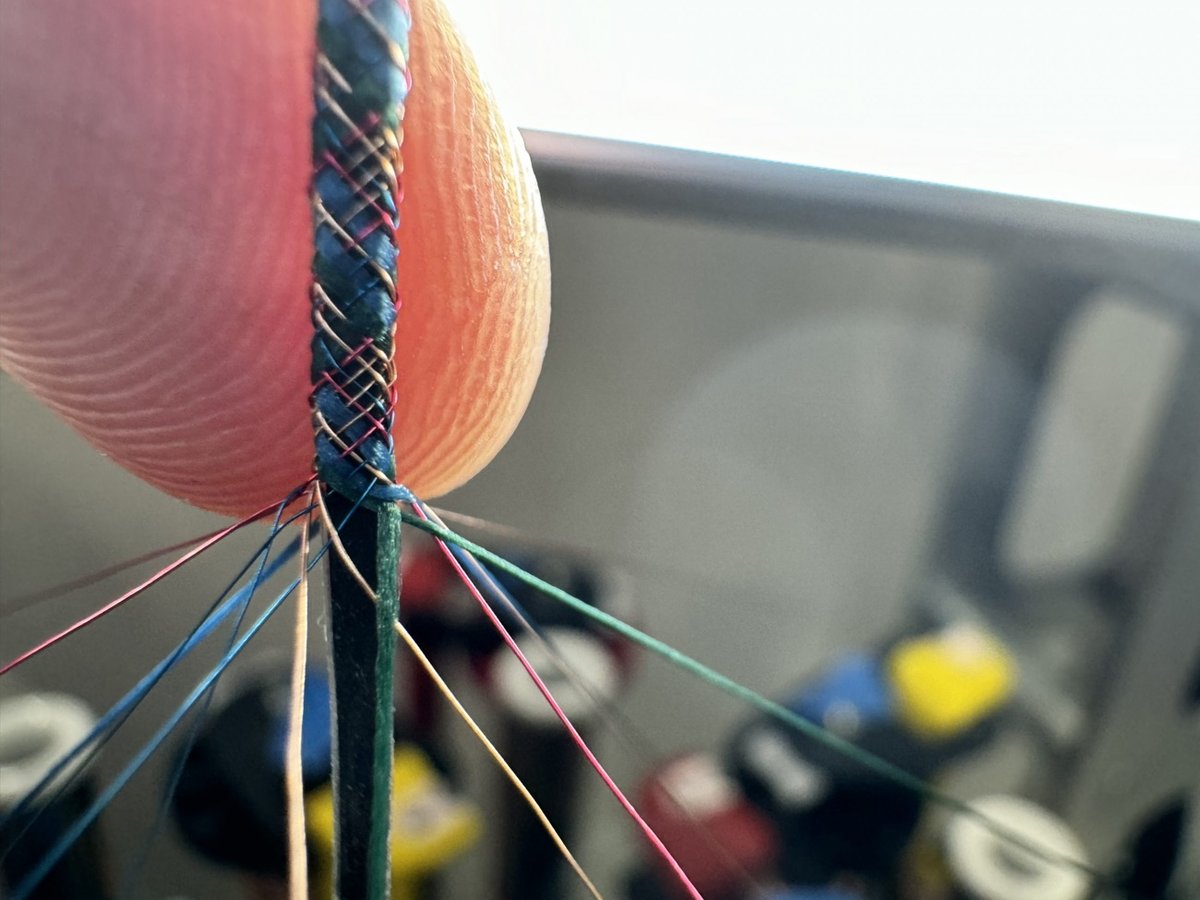Braiding a computer fiber with a combination of metal and textile yarns