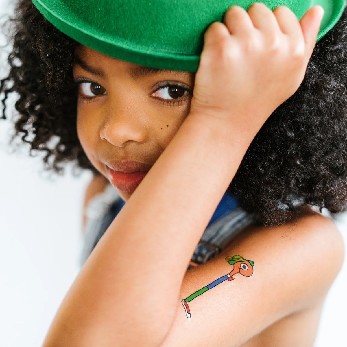 a girl with a Lowly Worm temporary tattoo on her arm