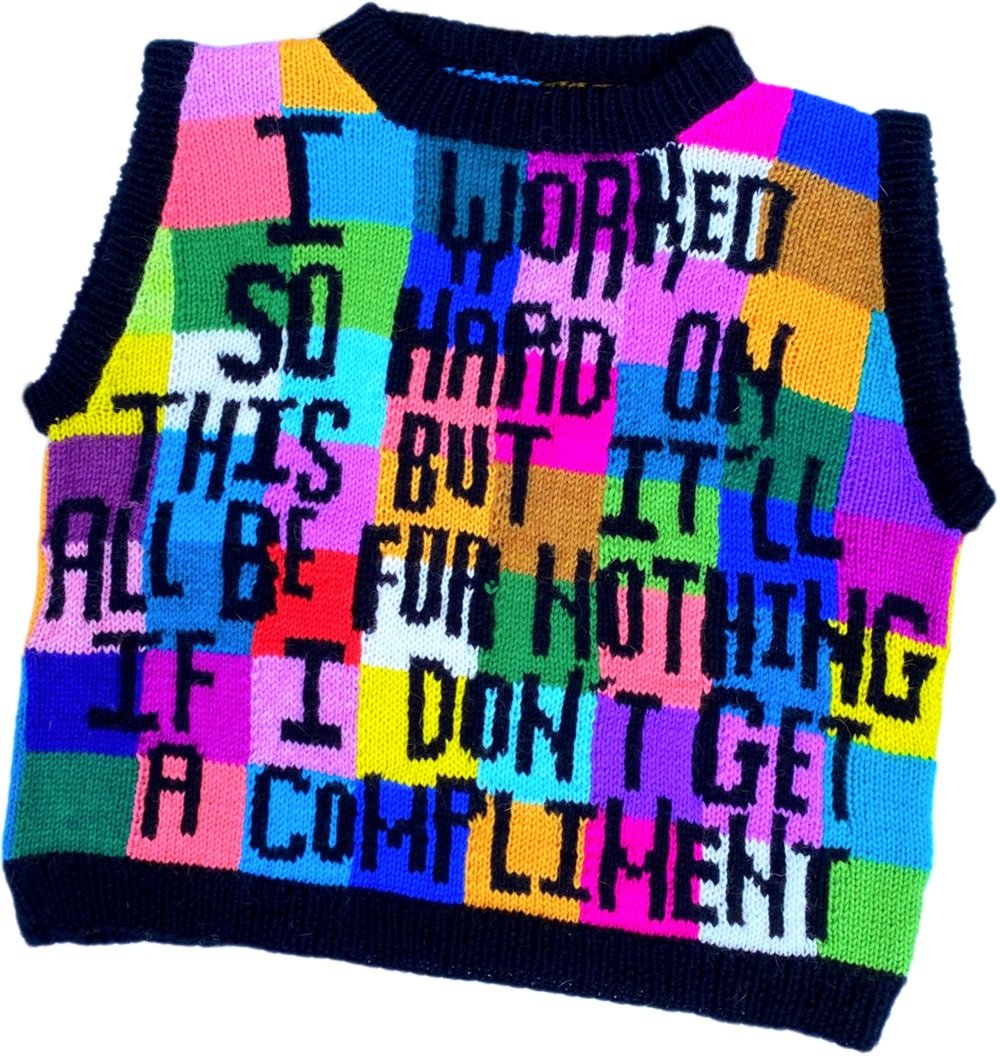 a brightly colored sweater with lots of words knitted into it