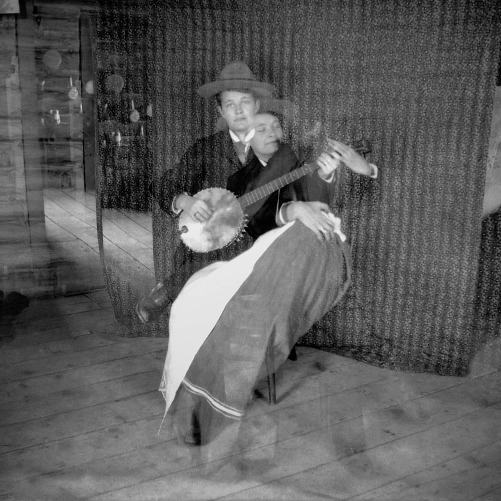 a double exposed photo of a woman playing a banjo