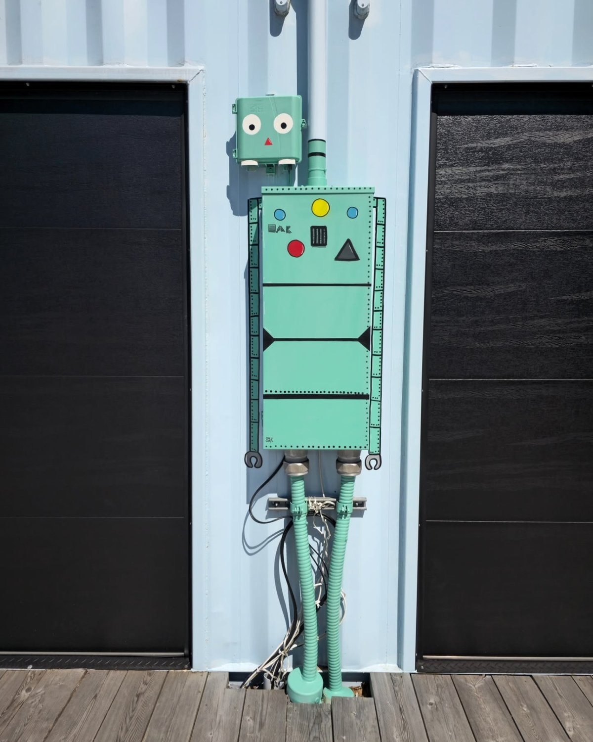 a utility box painted to look like a robot