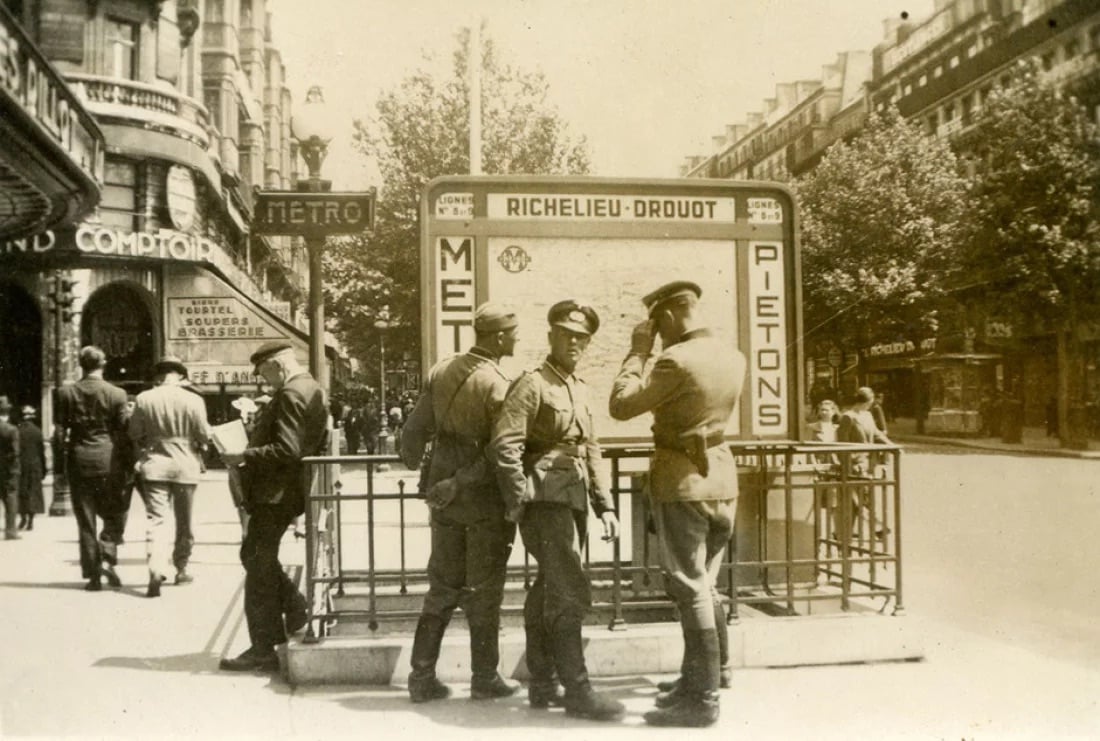 A photograph of German soldiers at the entrance to the Richelieu Drouot metro station in Paris, taken on July 14, 1940