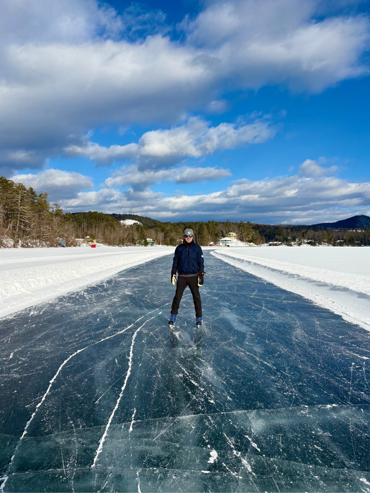 a man on a frozen path on a snowy lake