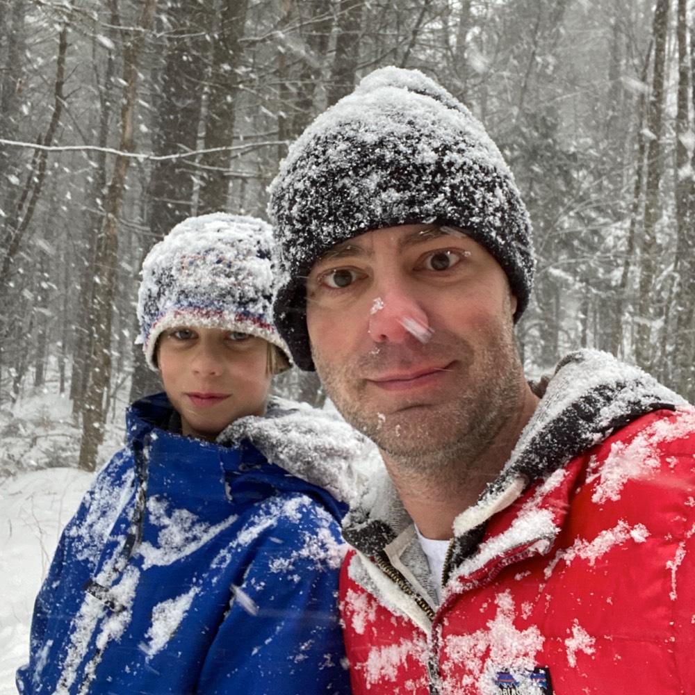 Two people out walking in a snowstorm