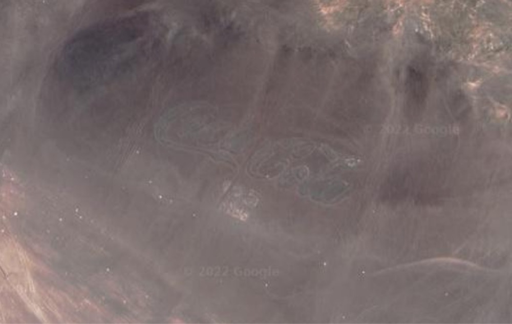 satellite image of a huge Coca-Cola logo in the Chilean desert