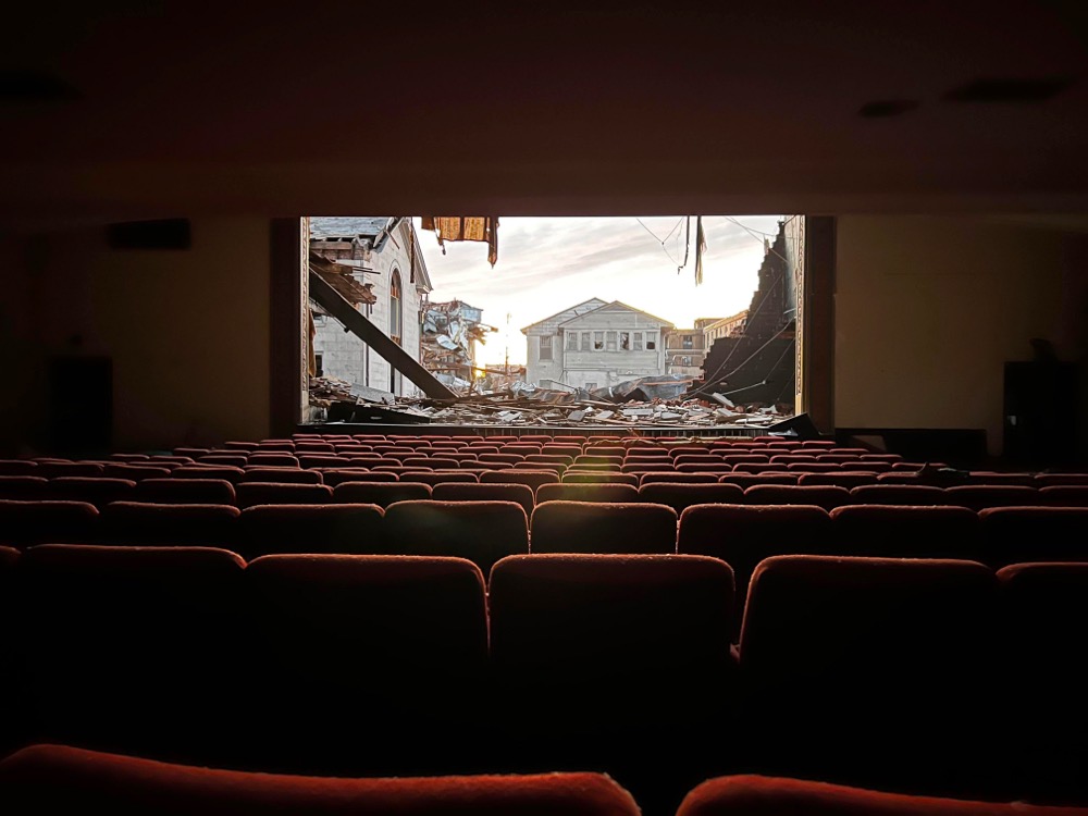 tornado debris is visible from inside a movie theater