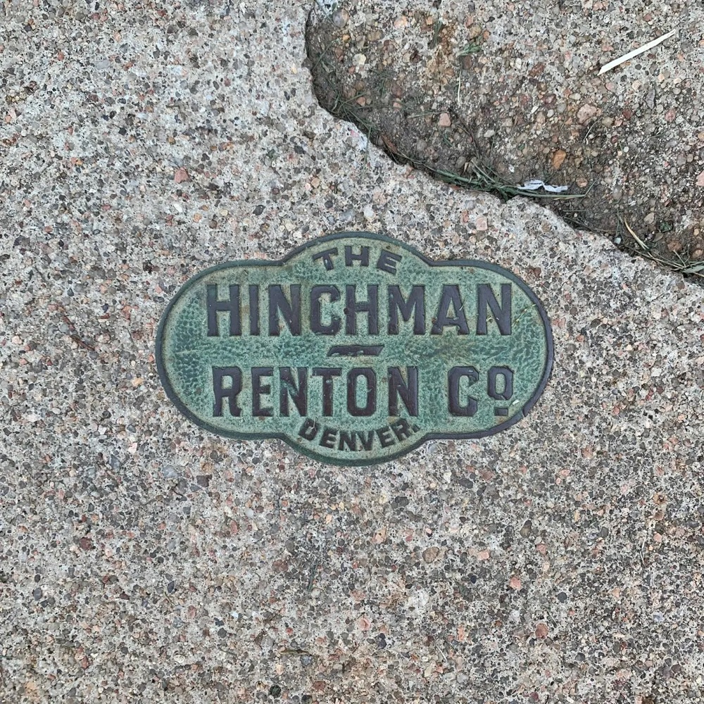 a sidewalk stamps that reads 'The Hinchman Renton Co. Denver'
