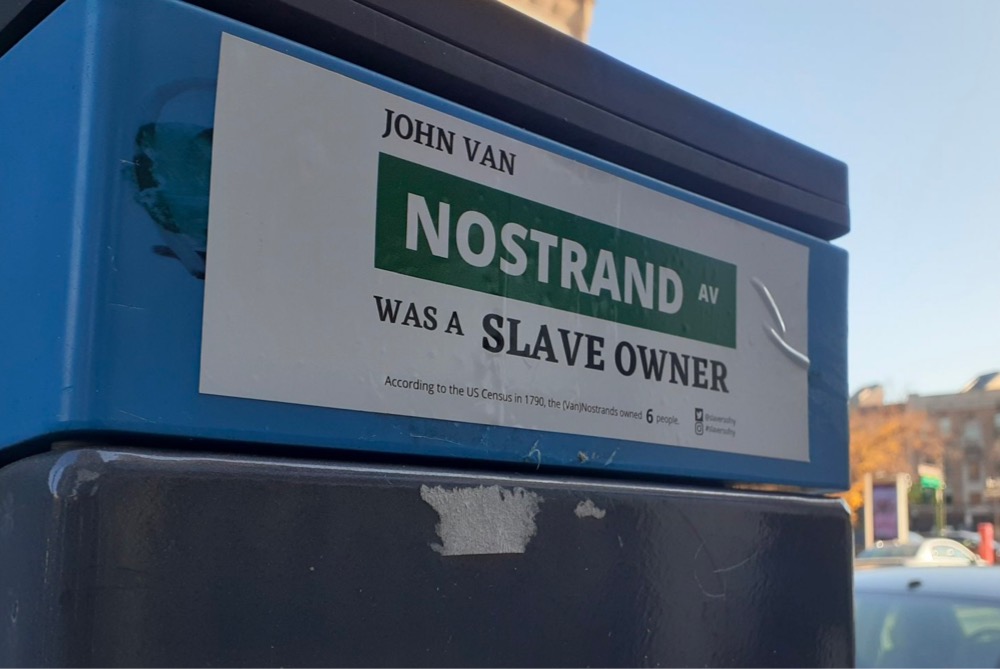 sticker that says 'John van Nostrand was a slave owner'